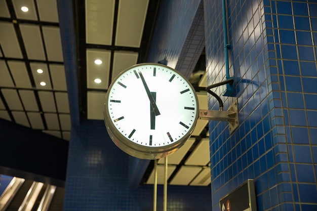 vintage style clock hanger inside train station