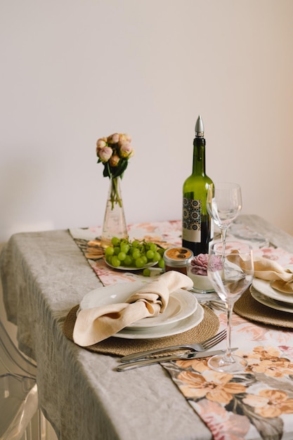 Vintage table setting with Linen napkins and floral decorations Close up Cozy calm meal in the morning in the sunshine