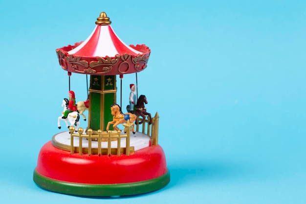 Vintage toy carousel on a blue background Red carillon with carousel retro carousel