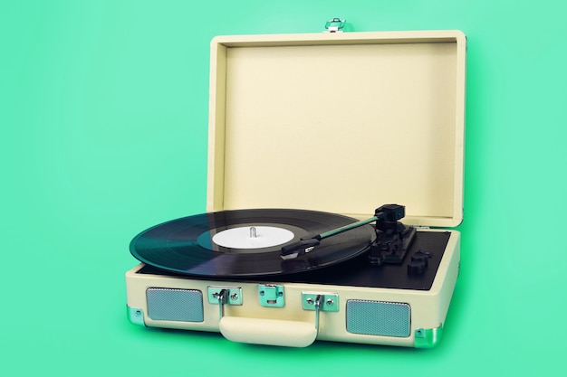 Vintage vinyl record player isolated on blue background