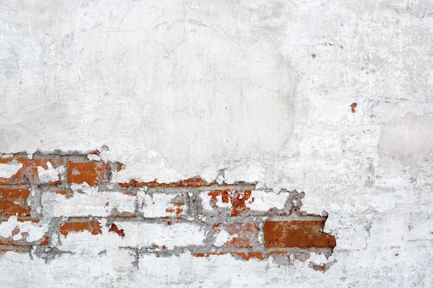 Vintage white red brick Wall With Peeled Plaster