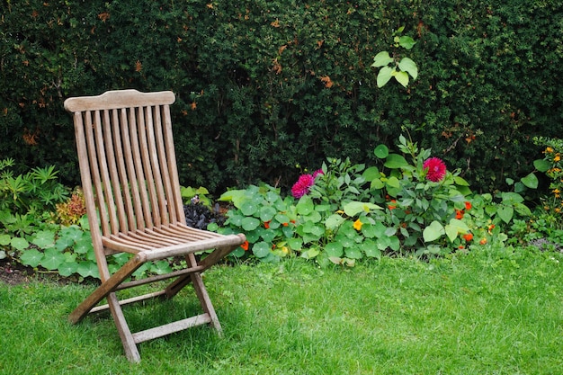 Vintage wooden chair in green country garden