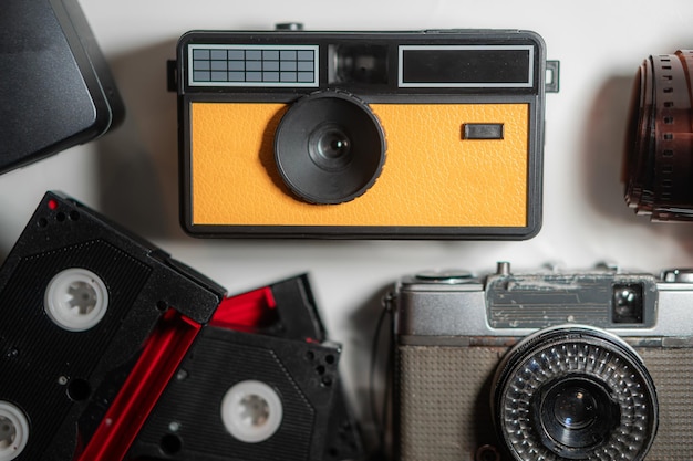 Photo vintage yellow camera with film and cassette tapes