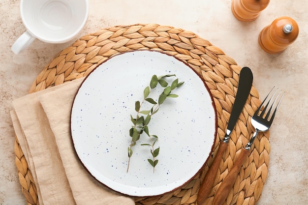 Vintage zero waste silverware Rustic vintage set of white plate wooden spoon and fork on napkin for dishes from water hyacinth on light gray concrete background Empty dishes Top view Mock up