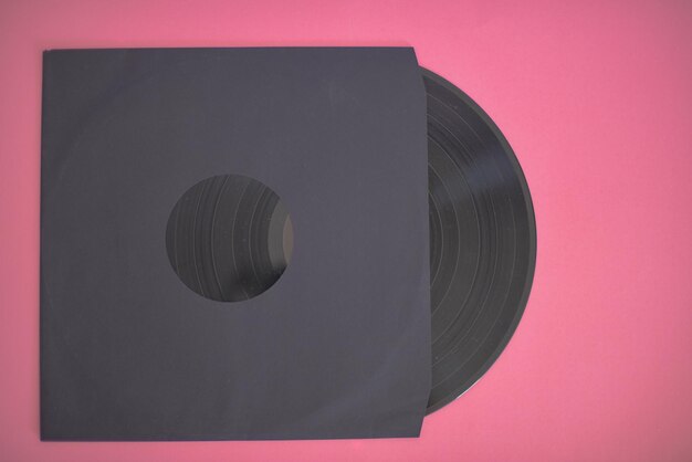 Photo vinyl record in sleeve isolated against pink background