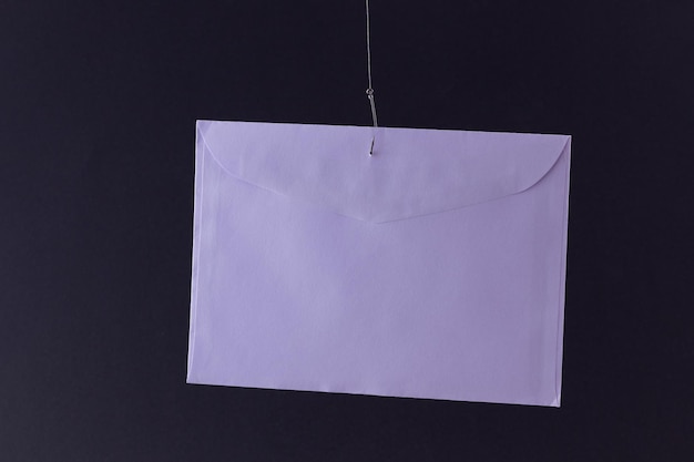 Violet envelope hanging on a fishing hook