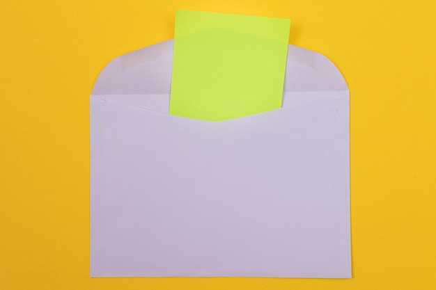 Violet envelope with blank green sheet of paper inside