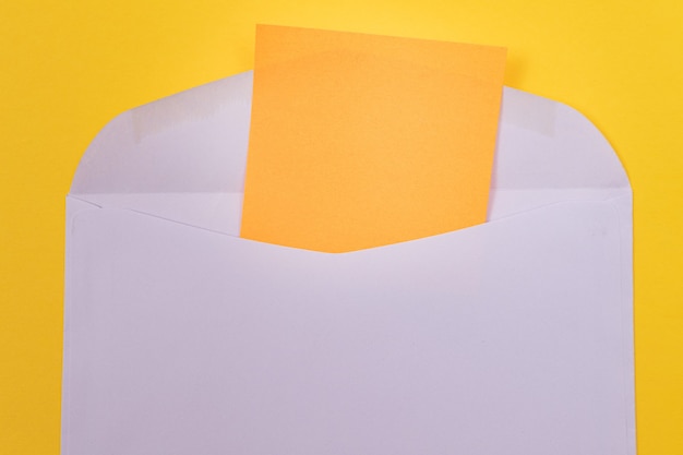 Violet envelope with blank orange sheet of paper inside