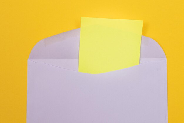 Violet envelope with blank yellow sheet of paper inside