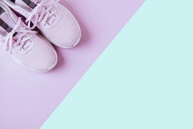 Violet sneakers, pink and blue background.