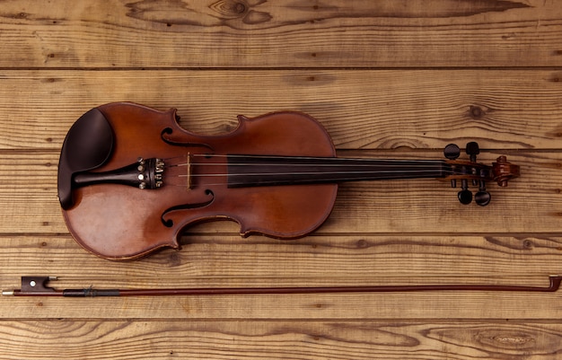 Violin close up lying on the wood table.