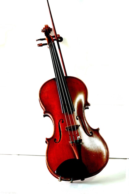 Violin with fiddle stick on a white background