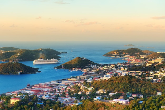 Virgin Islands St Thomas sunrise with colorful cloud, buildings and beach coastline.