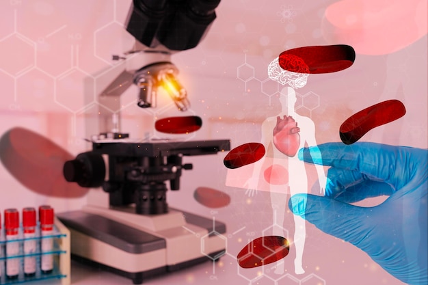 Virologist's hand in glove testing coronavirus vaccine under microscopelab assistant testing blood