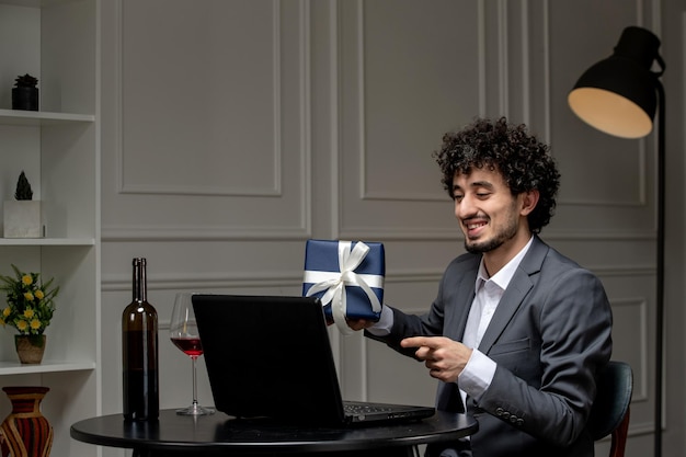 Virtual love handsome cute guy in suit with wine on a distance computer date giving present