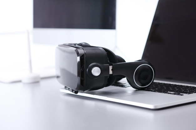 Virtual reality goggles on desk with laptop business 3d technology