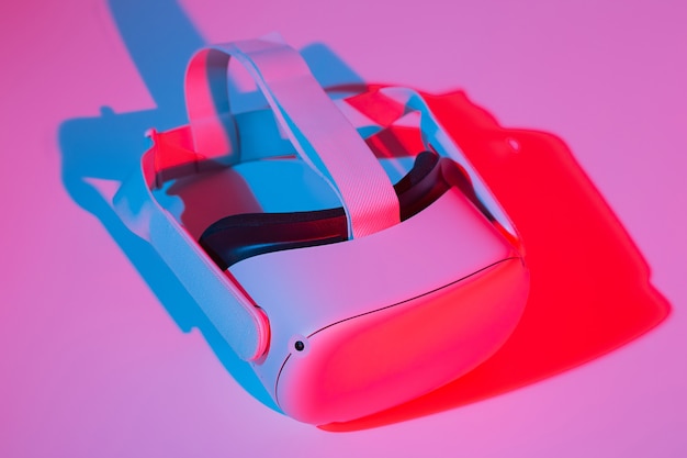 Virtual reality helmet on white background in neon light vr technology concept