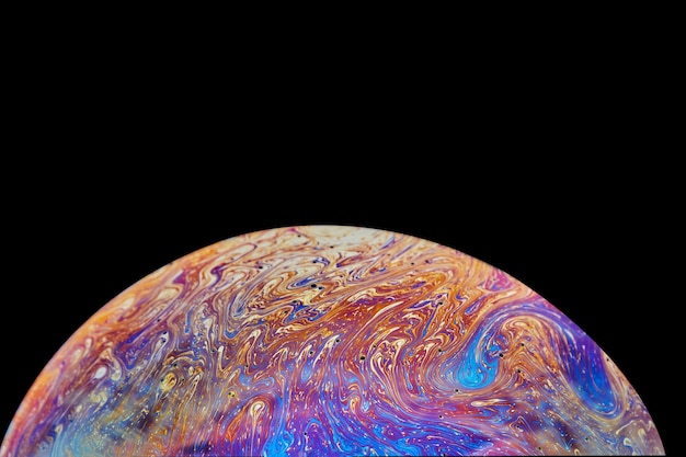 Virtual reality space with abstract multicolor psychedelic planet Closeup Soap bubble like an alien planet on black background