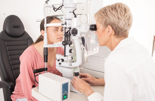 Vision eye and test with optometrist for glasses eyecare and eyes wellness in medical office Ophthalmologist ophthalmology and healthcare optician exam for prescription eyewear and health