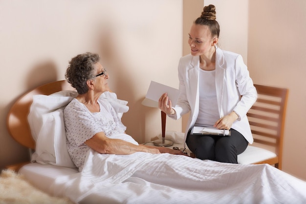 Visit of senior social work assistant to an old woman