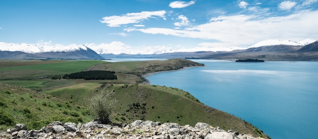 vista with beautiful alpine scenery turquoise glacier lake with snowy mountains tekaponew zealand