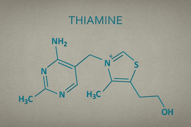 Vitamin b thiamine molecule on paper texture background skeletal formula of vitamin b recessed text