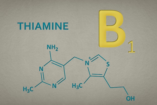 Vitamin b thiamine molecule on paper texture background skeletal formula of vitamin b recessed text