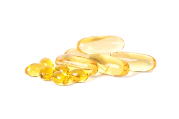 Vitamin D Yellow pills slide isolated on white background Vitamins are antibiotics Omega 3