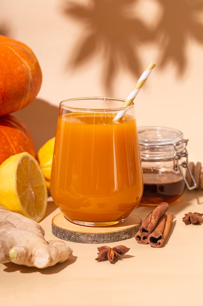 Vitamin pumpkin drink with ginger honey and lemon Autumn pumpkin juice vertical photo