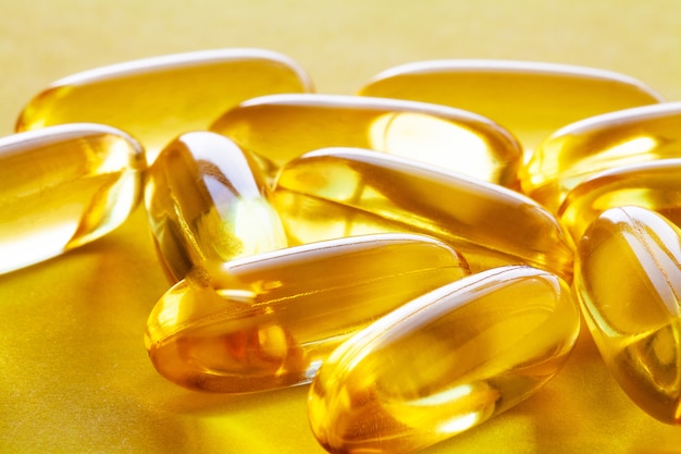 Vitamins supplements, fish oil in yellow capsules omega 3.