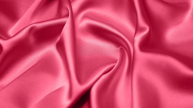 Viva Magenta toned red magenta fabric atlas. Close up pink silk satin texture for sewing