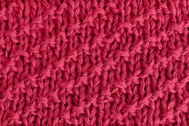 Viva Magenta trendy color 2023 knitted background in red jersey Knitted fabric