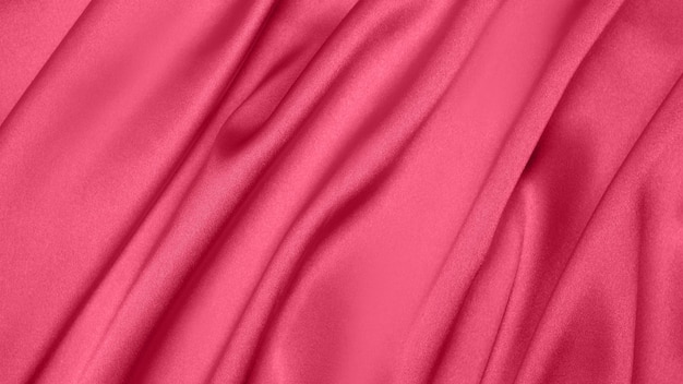 Viva Meganta toned red magenta fabric atlas. Close up pink silk satin texture for sewing