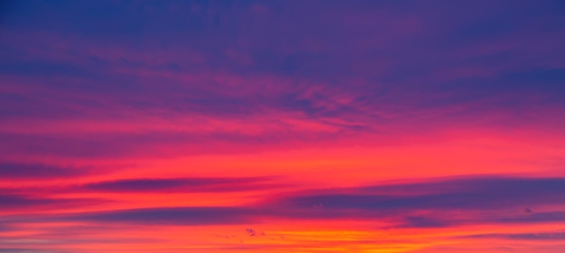 Vivid saturated beautiful sunset sky in orange, purple and red colors. Sunset background.