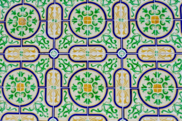 Vivid vintage tiles with mosaic ornate on the wall outside downtown Aveiro Portugal