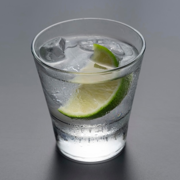 Vodka or gin with lime in rocks glass