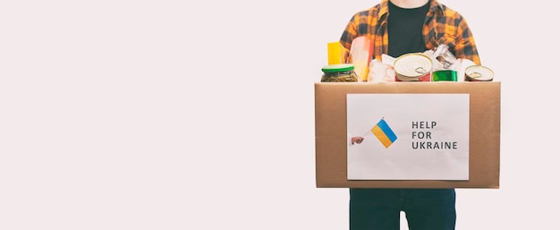 The volunteer packing the bag with groceries and necessary things for people in need