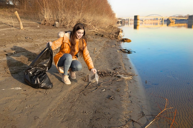 Volunteer picking up the trash from the beach