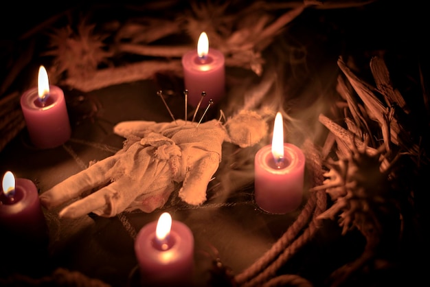 Voodoo doll on a wooden background with dramatic lighting