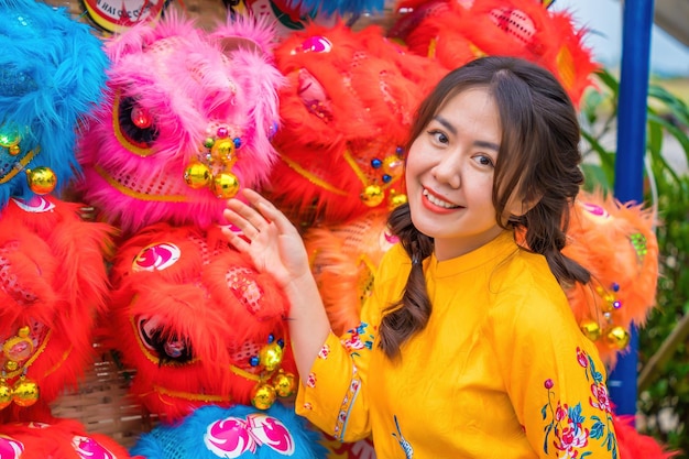 Vung Tau VIETNAM JAN 7 2023 Young girl smiling and standing near lion dance show in chinese new year festival Tet festival lion Dance dragon and lion dance street performances in Vietnam