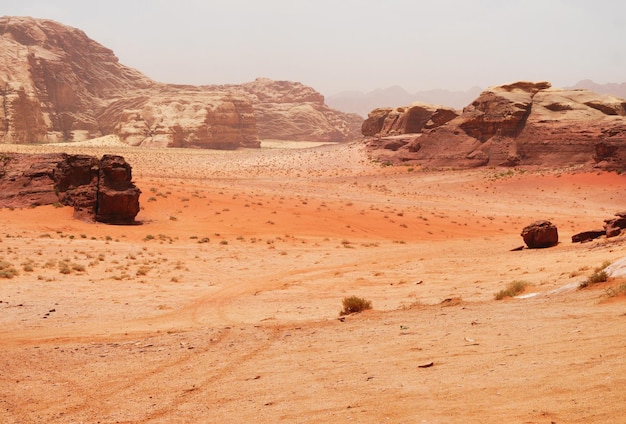 Wadi Rum desert Jordan Middle East The Valley of the Moon Orange sand haze and clouds Designation as a UNESCO World Heritage Site Red planet Mars landscape