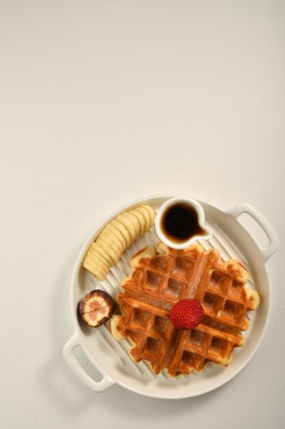 waffle plate with pieces of fruits, oriental sweets.