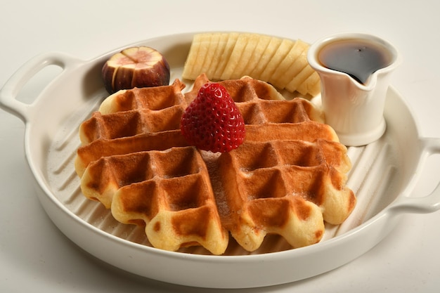 waffle plate with pieces of fruits, oriental sweets.