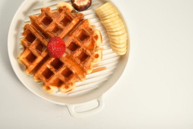 waffle plate with pieces of fruits, oriental sweets.