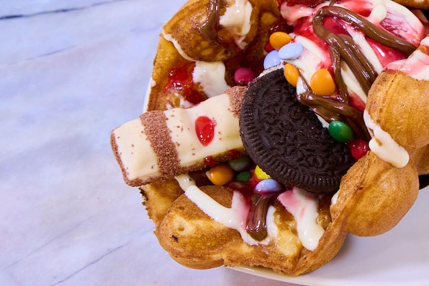 waffle with chocolate ice cream strawberry sauce and sweets