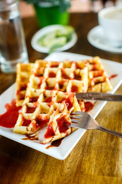 Waffles and coffee on the wooden table