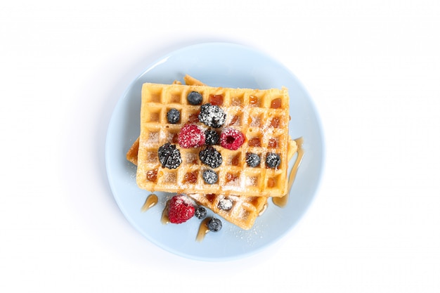 Waffles with berries on plate