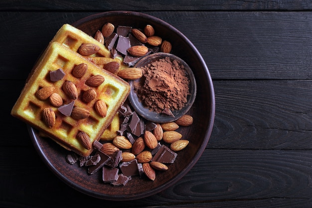 waffles with chocolate and almond nuts top view.