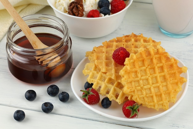 Waffles with honey and berries for breakfast