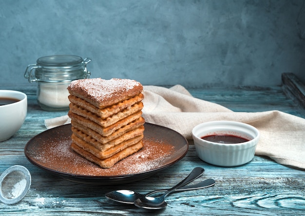 Waffles with vanilla on grey wooden background with space for copy.